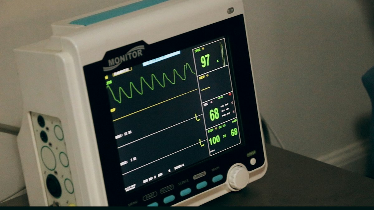 Patient monitor showing heart rate and oxygen levels in a hospital